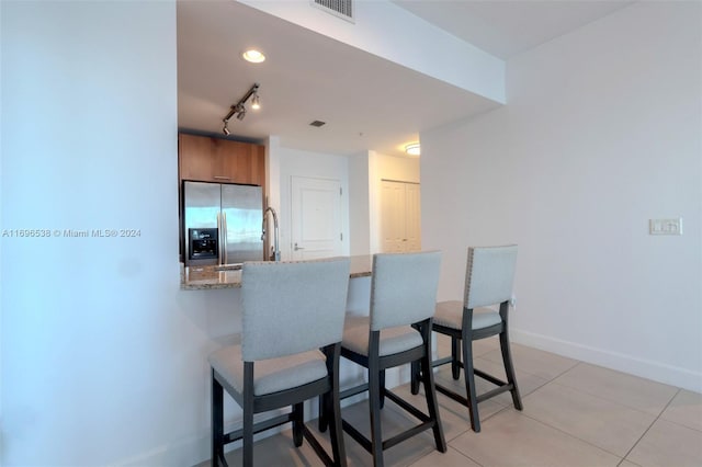 1945 S Ocean Dr Unit M5, Hallandale Beach, FL 33009 - dining space featuring baseboards, light tile patterned flooring, and track lighting