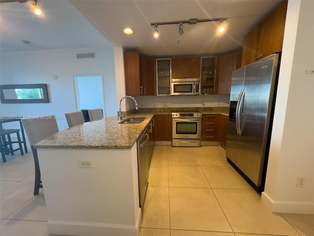 1945 S Ocean Dr Unit M5, Hallandale Beach, FL 33009 - kitchen with appliances with stainless steel finishes, rail lighting, a sink, and light tile patterned flooring