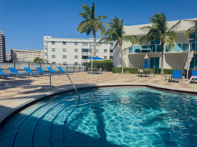 view of pool with a jacuzzi and a patio