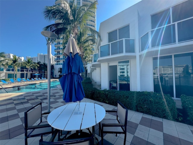 1945 S Ocean Dr Unit M5, Hallandale Beach, FL 33009 - view of patio with a community pool and outdoor dining space