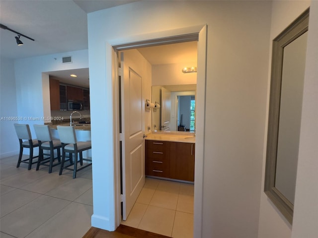 1945 S Ocean Dr Unit M5, Hallandale Beach, FL 33009 - hallway with light tile patterned floors, rail lighting, and baseboards