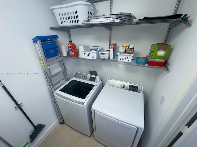 1945 S Ocean Dr Unit M5, Hallandale Beach, FL 33009 - laundry area with washer and dryer and light tile patterned floors