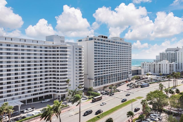 view of building exterior with a water view and a city view