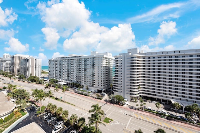 view of building exterior featuring a city view and a water view