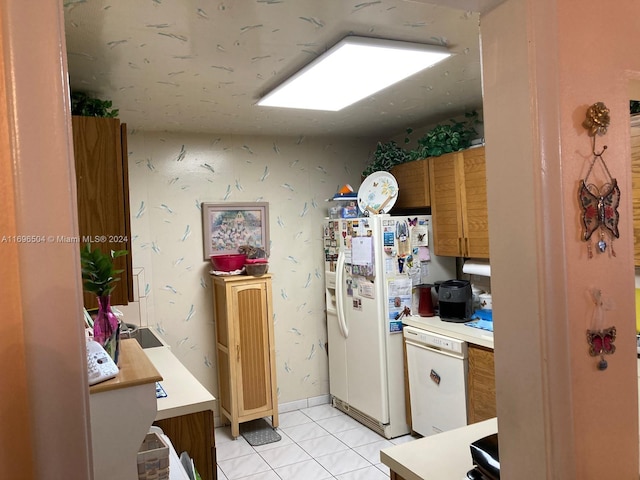 kitchen featuring white appliances and light tile patterned floors