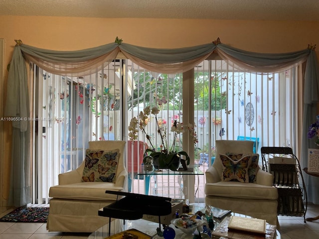 living room with tile patterned flooring, a textured ceiling, and a healthy amount of sunlight