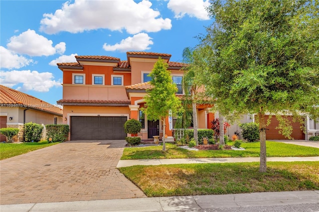 mediterranean / spanish home with a front yard and a garage