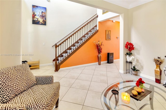 stairway with tile patterned flooring and ornamental molding