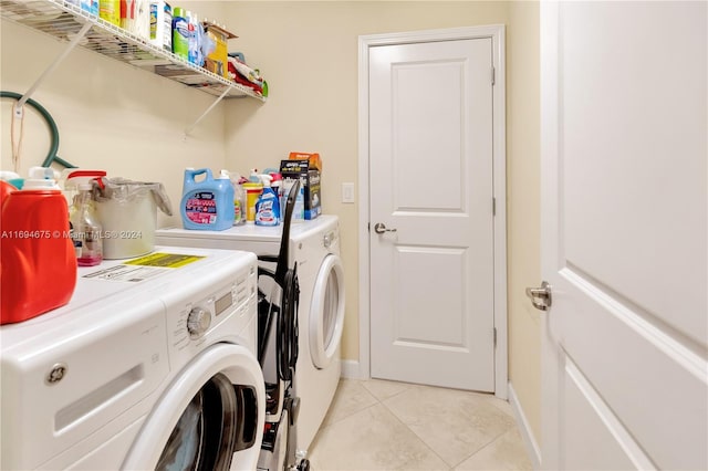 washroom featuring independent washer and dryer and light tile patterned floors