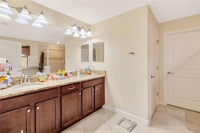 bathroom with tile patterned flooring, vanity, and walk in shower