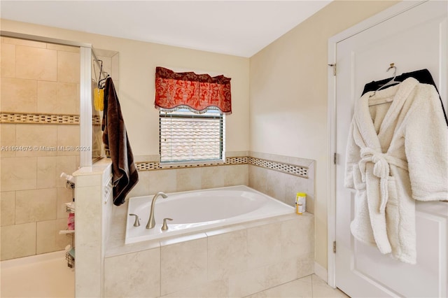 bathroom featuring tile patterned flooring and independent shower and bath