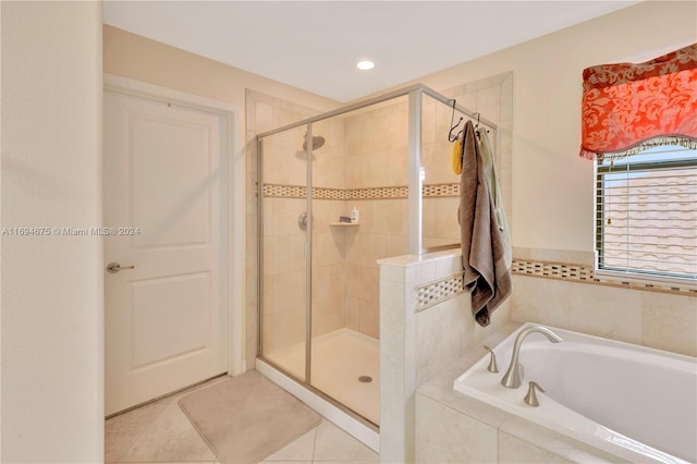 bathroom featuring tile patterned floors and independent shower and bath