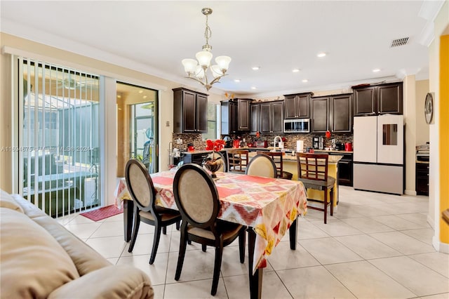 tiled dining space with a notable chandelier and crown molding