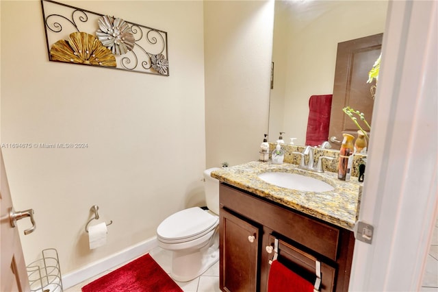 bathroom featuring tile patterned flooring, vanity, and toilet