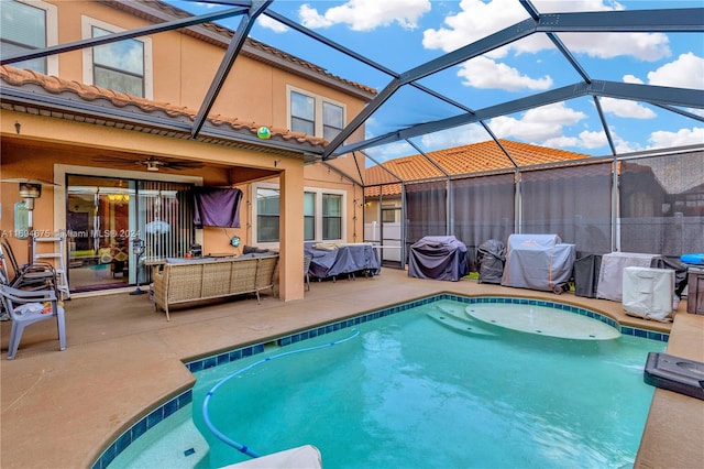 view of swimming pool with a lanai, grilling area, and a patio area