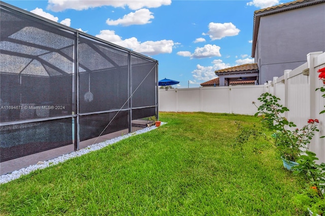 view of yard featuring glass enclosure