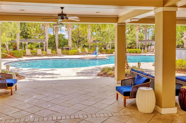 view of pool with a pergola, ceiling fan, and a patio area