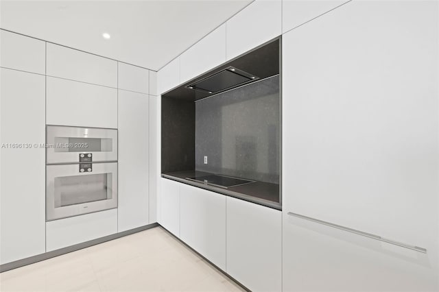 kitchen with dark countertops, modern cabinets, white cabinetry, and black electric stovetop