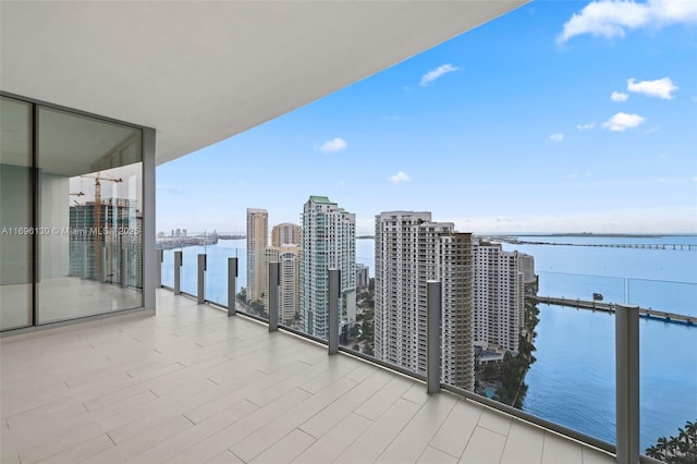 balcony with a view of city and a water view