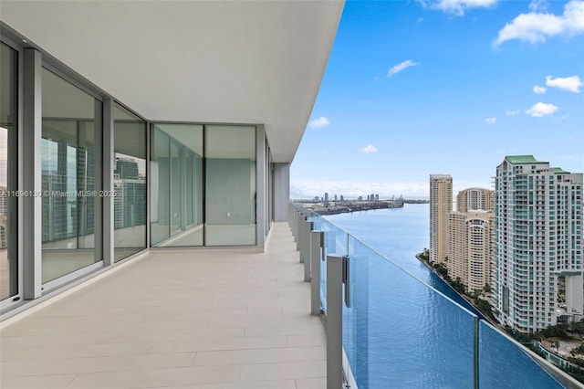balcony with a water view and a city view