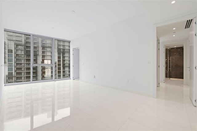 empty room with recessed lighting, visible vents, and tile patterned floors