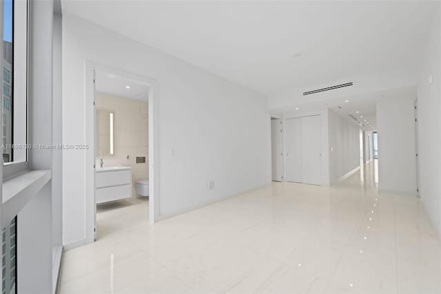 spare room featuring light tile patterned floors, a sink, recessed lighting, and visible vents