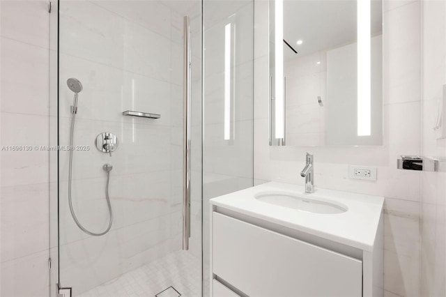 bathroom featuring a shower stall and vanity