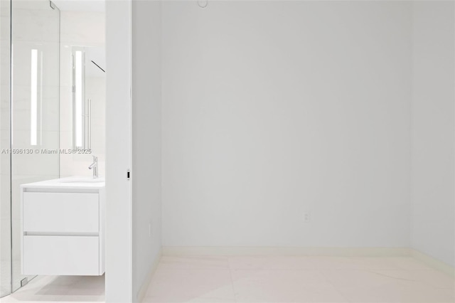 bathroom with vanity and baseboards