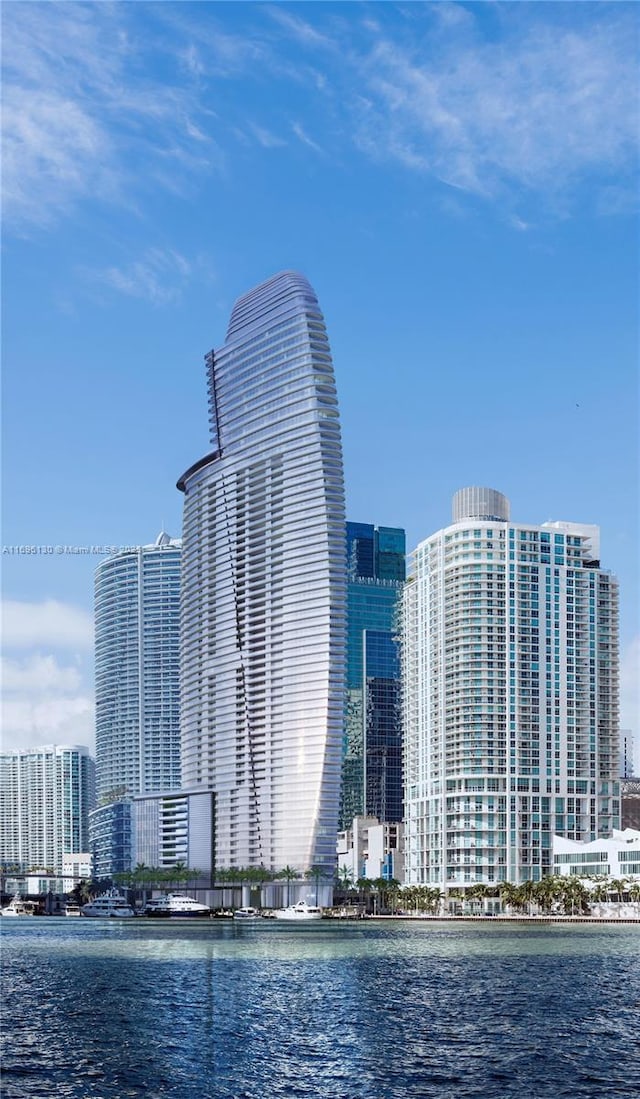 view of building exterior with a water view and a city view