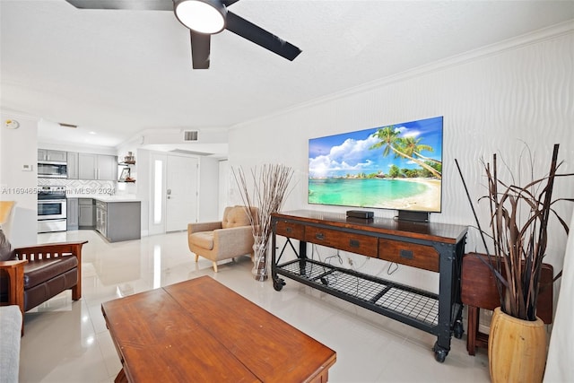 living room featuring light tile patterned floors, ceiling fan, and ornamental molding