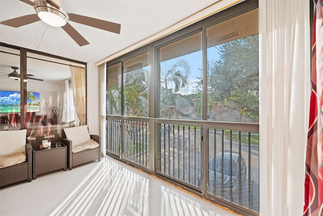 sunroom / solarium featuring ceiling fan