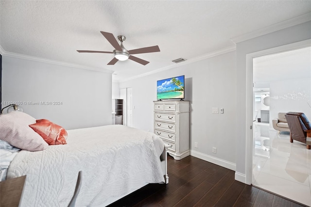 bedroom with ceiling fan, dark hardwood / wood-style floors, ensuite bathroom, a textured ceiling, and ornamental molding