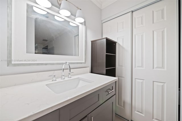 bathroom featuring vanity and ornamental molding