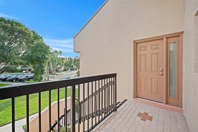 view of exterior entry with a balcony