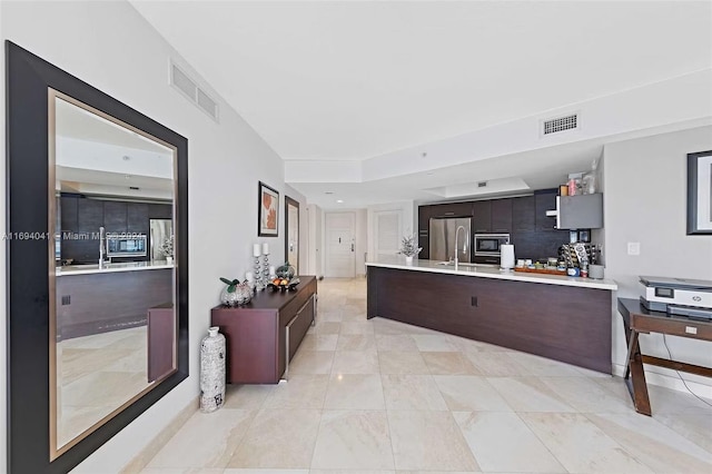 kitchen featuring appliances with stainless steel finishes and dark brown cabinetry