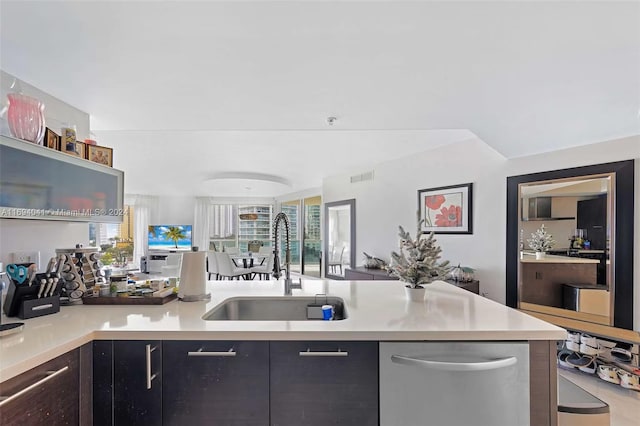 kitchen featuring sink, stainless steel dishwasher, and dark brown cabinets