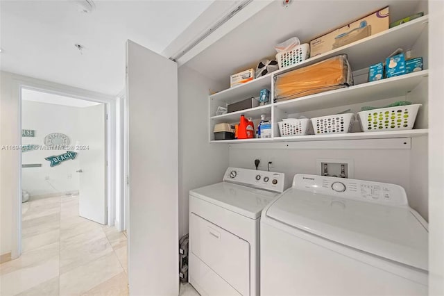 washroom featuring light tile patterned floors and washing machine and clothes dryer