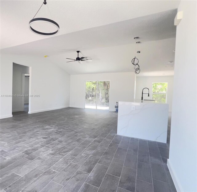 unfurnished living room featuring vaulted ceiling and hardwood / wood-style floors