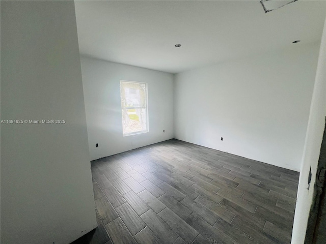 unfurnished room featuring dark wood-style floors