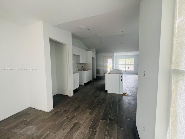 hall featuring wood tiled floor and vaulted ceiling