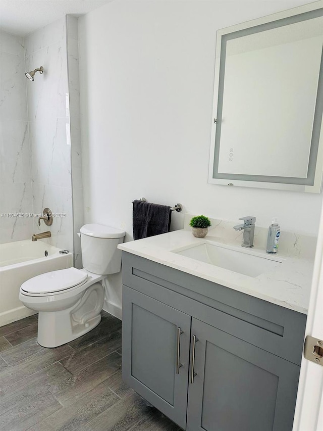 8036 104th Ct, Vero Beach, FL 32967 - bathroom featuring toilet, vanity, wood finished floors, and tub / shower combination