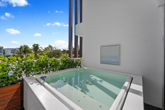 view of pool with an outdoor hot tub