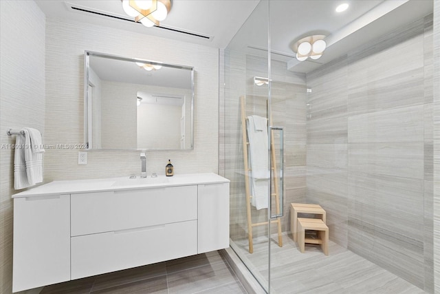 bathroom featuring vanity, an enclosed shower, and tile walls