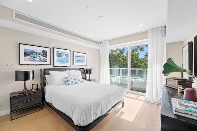 bedroom featuring access to outside and light wood-type flooring