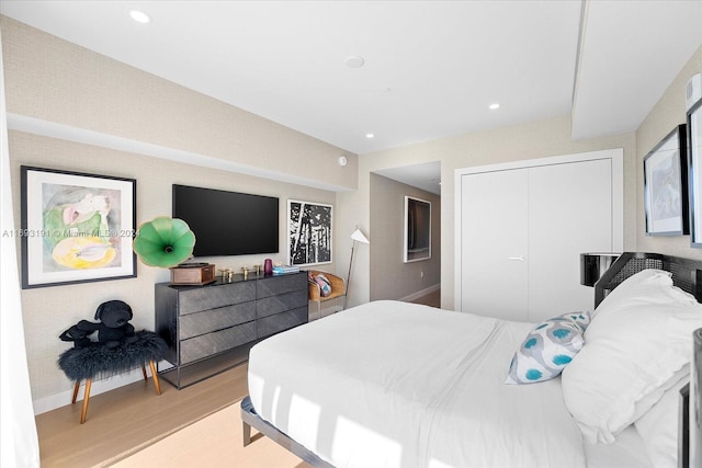 bedroom featuring a closet and light wood-type flooring