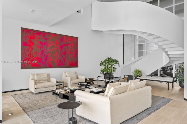 living room with a high ceiling and hardwood / wood-style flooring