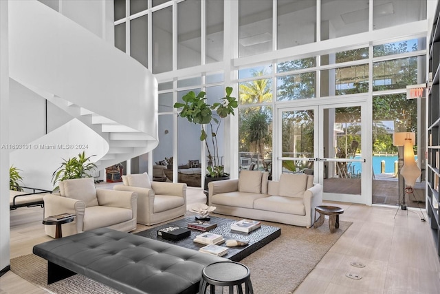 living room with french doors and a towering ceiling