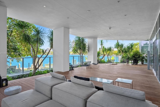 view of patio with a deck with water view