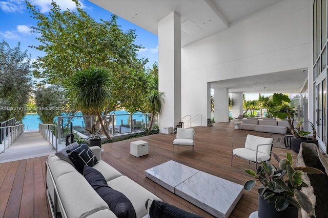 wooden deck featuring outdoor lounge area and a water view