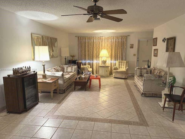 tiled living room with ceiling fan and a textured ceiling